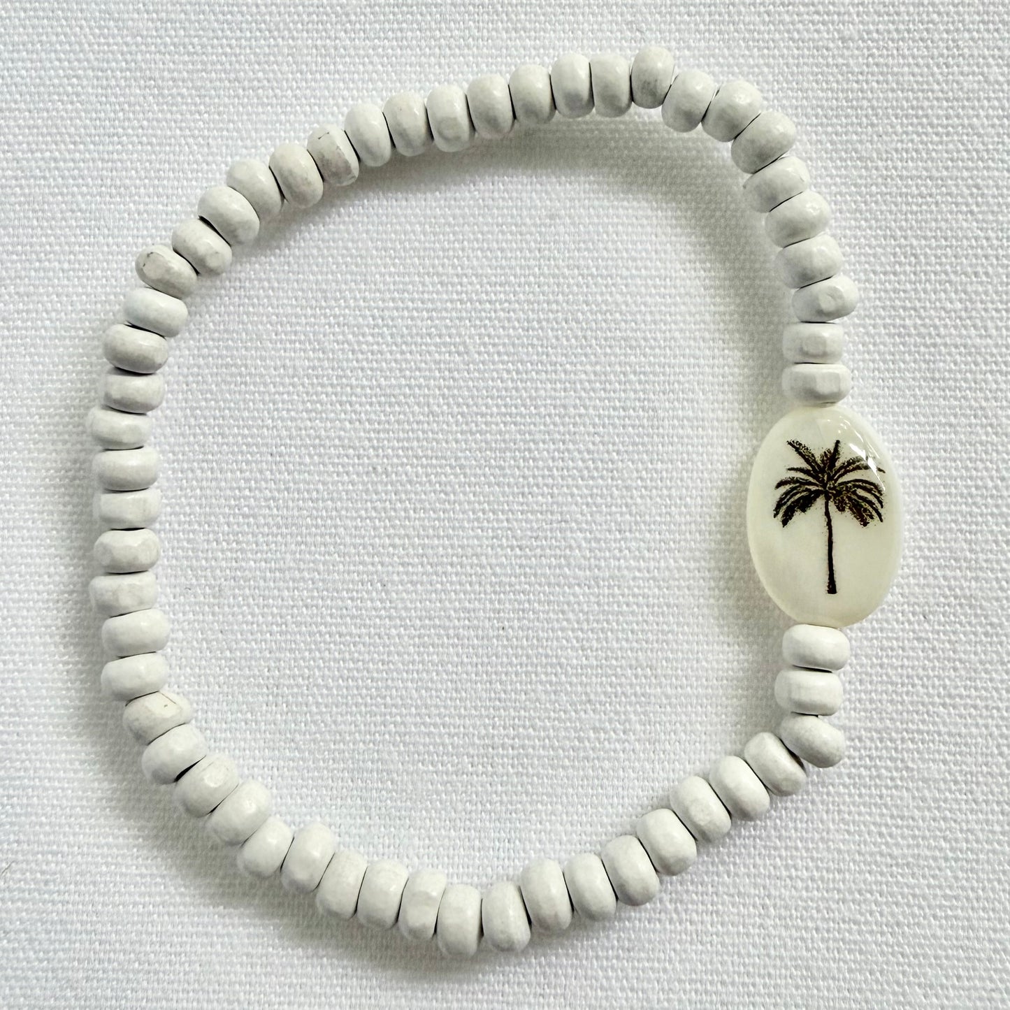 White wooden bracelet with silhoutte palm