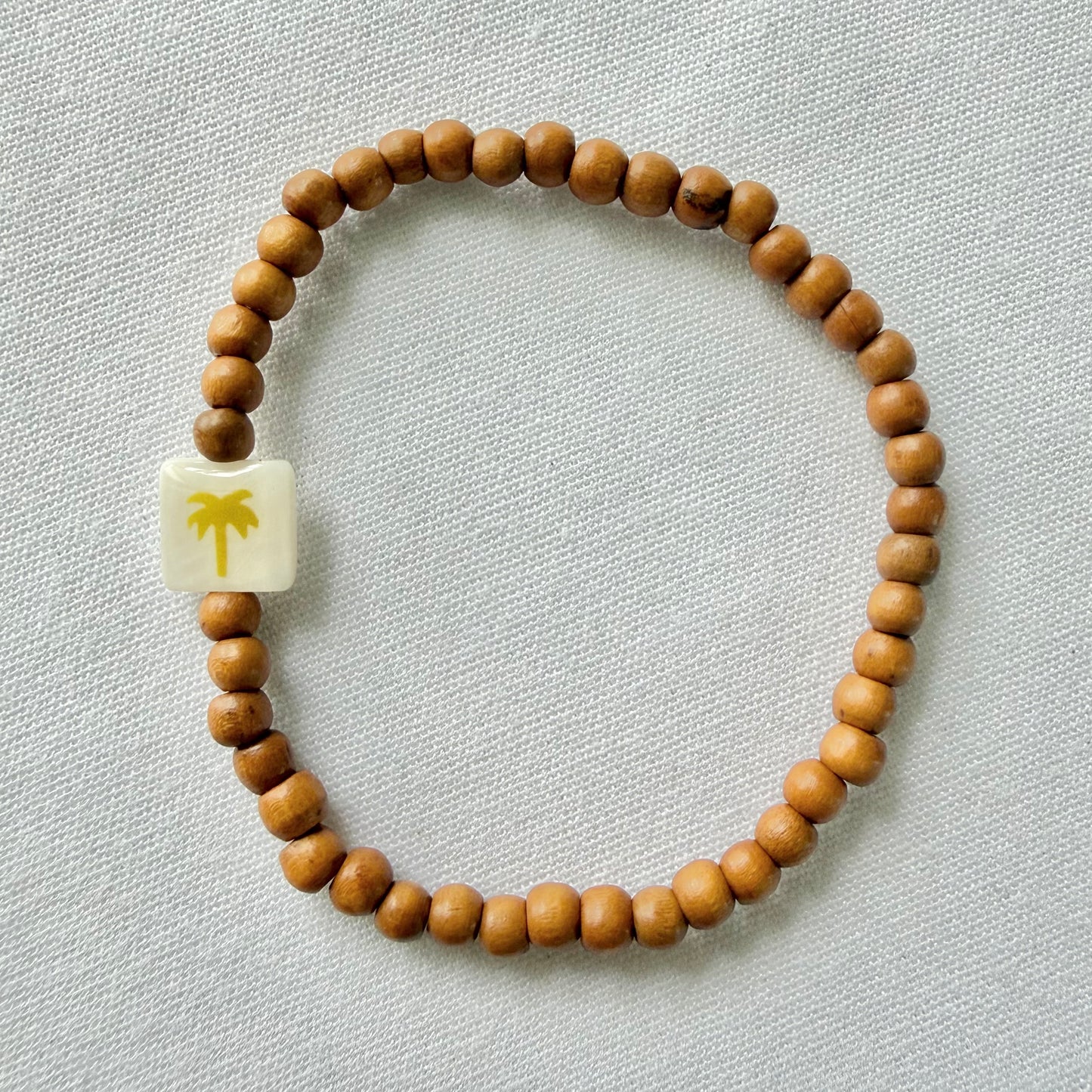 Wooden bracelet with gold palm tree
