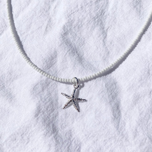 Starfish on white glass beads
