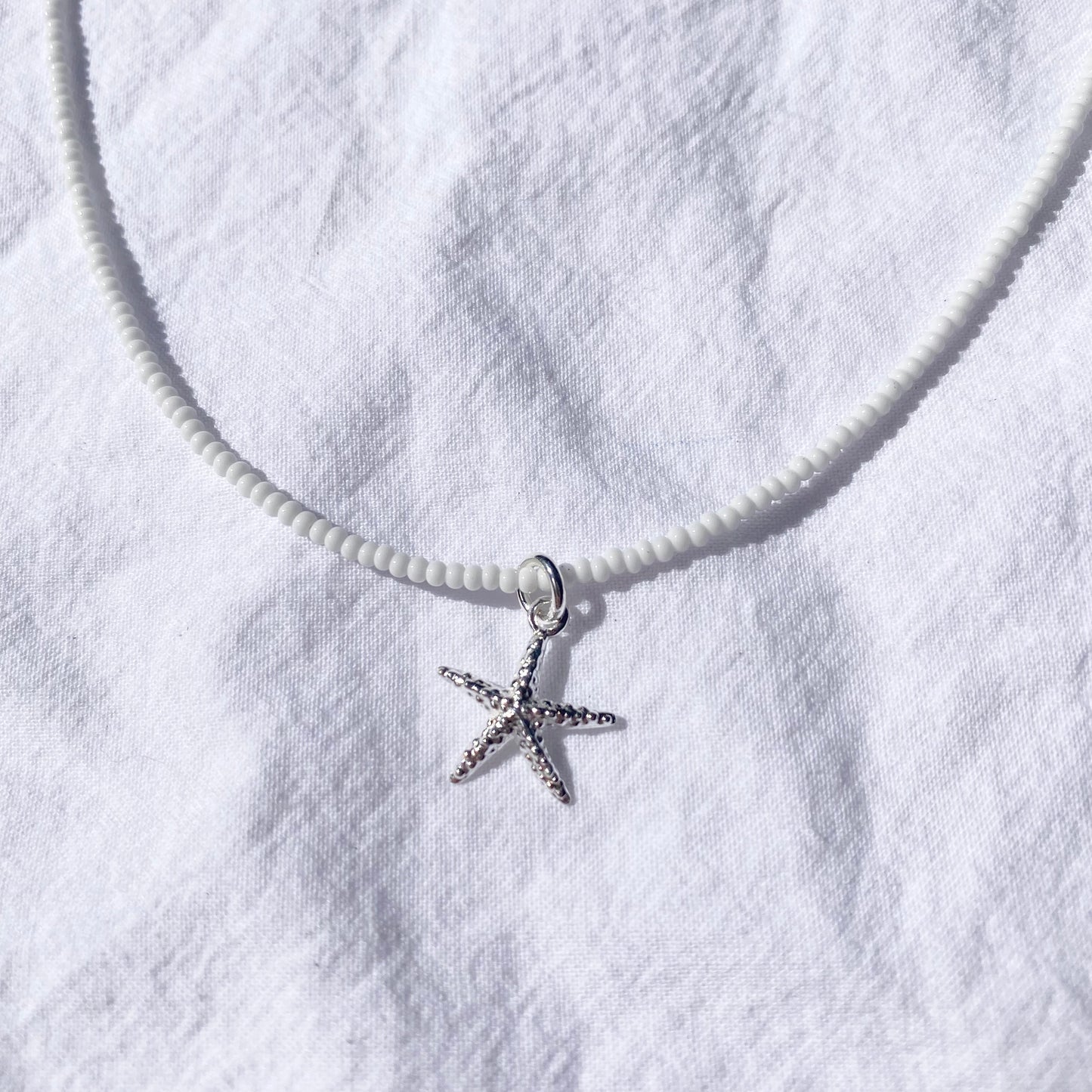 Starfish on white glass beads