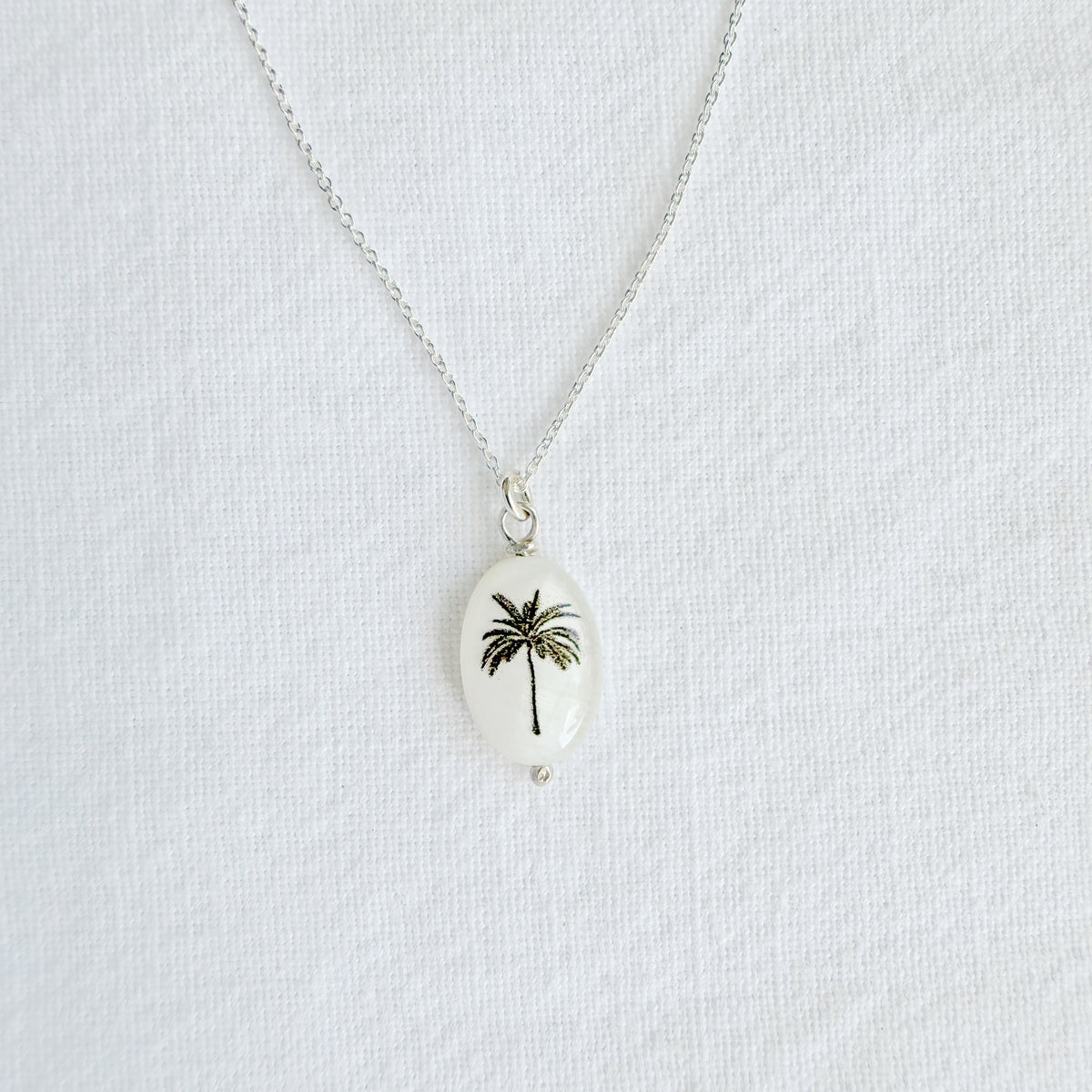 Silhouette oval palm tree on sterling silver chain