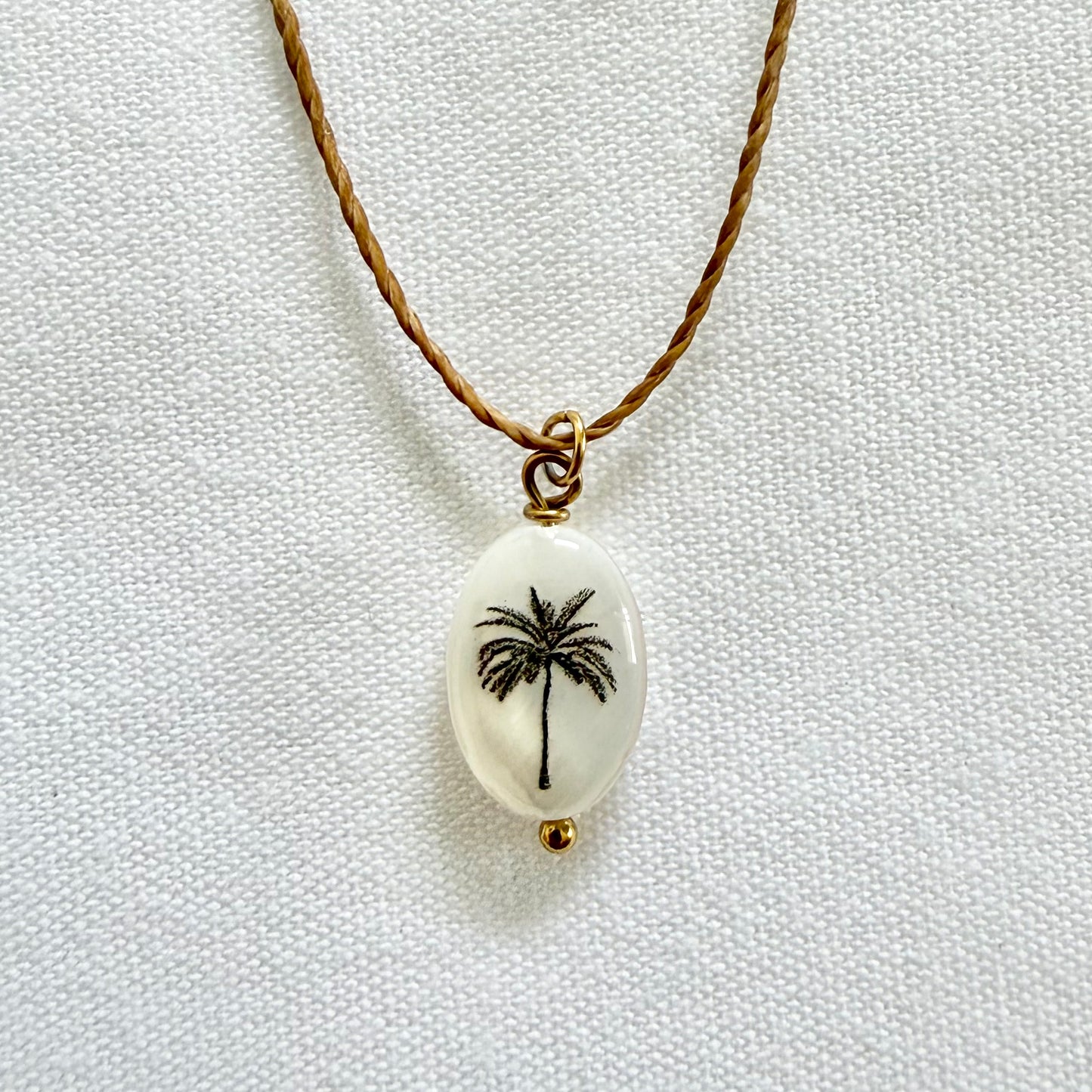 Silhouette palm on dark tan cord