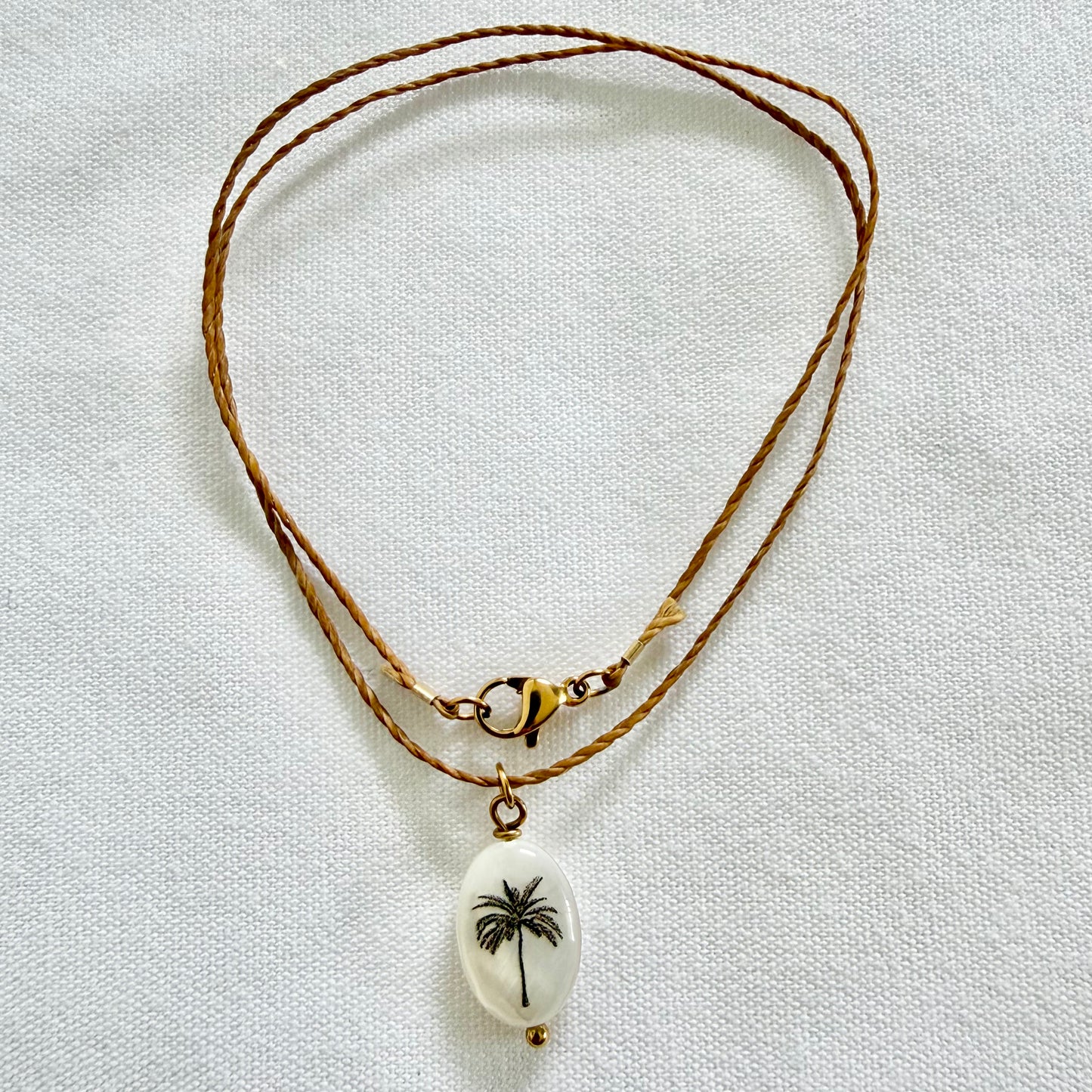 Silhouette palm on dark tan cord